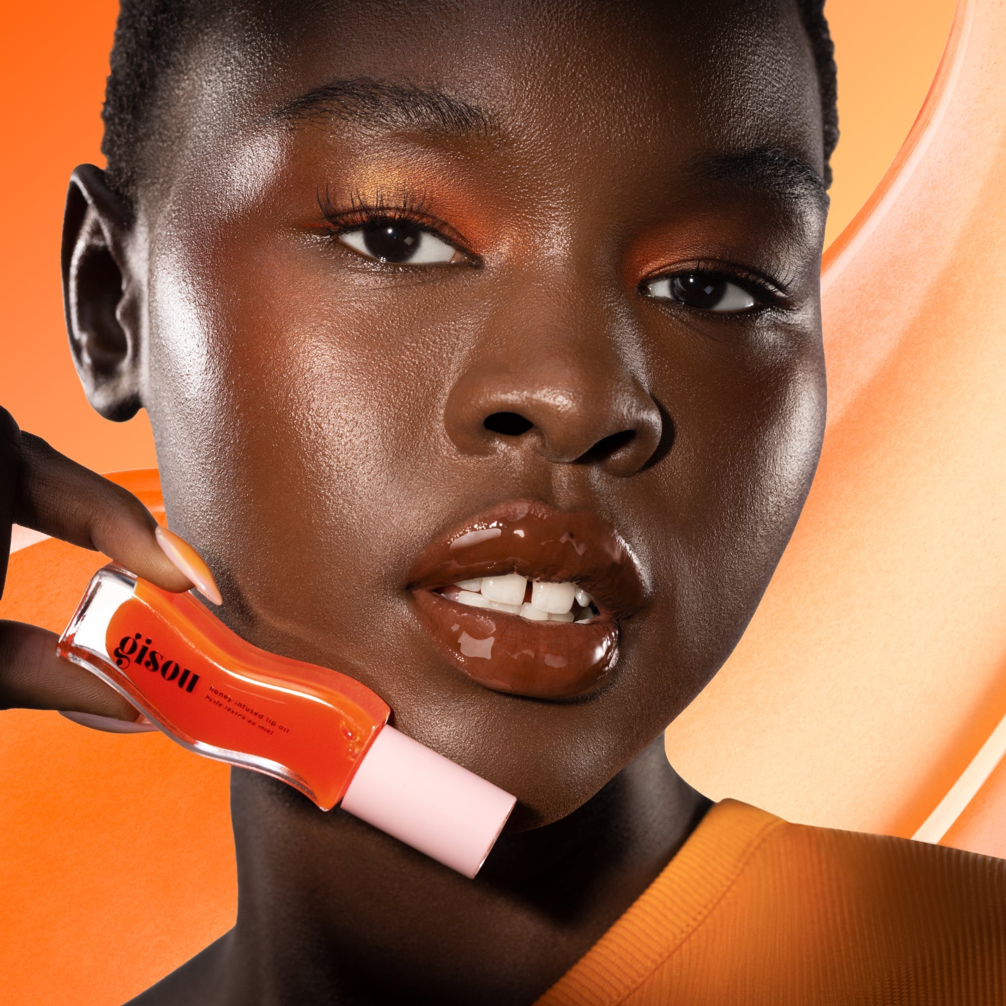 Model holding the mango lip oil.