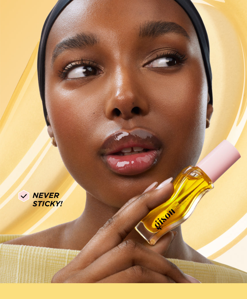 Model holding the lip oil bottle.