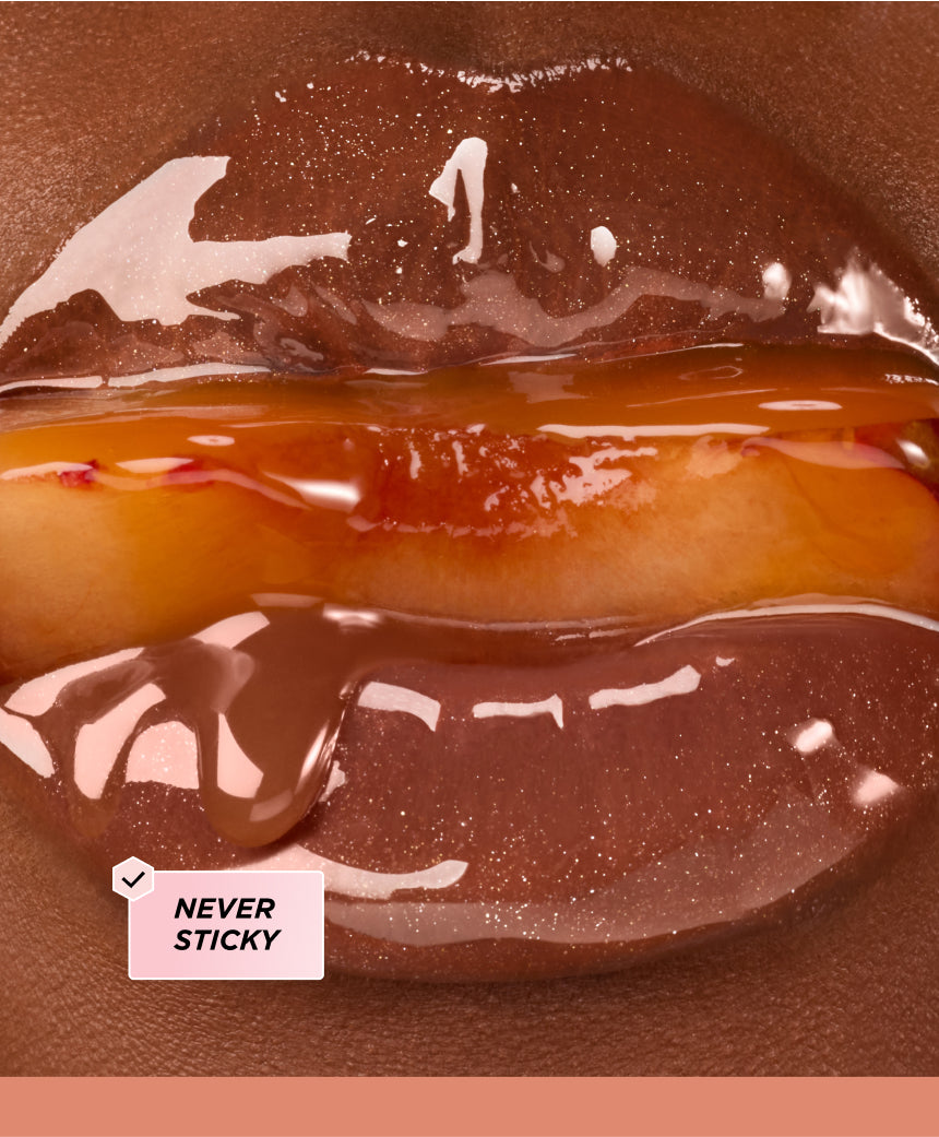 Close up of lips surrounding a peach.