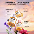 Three Gisou Hair Perfume bottles, each surrounded by their key ingredients: lavender, blackberries, honey, wild rose, and vanilla.