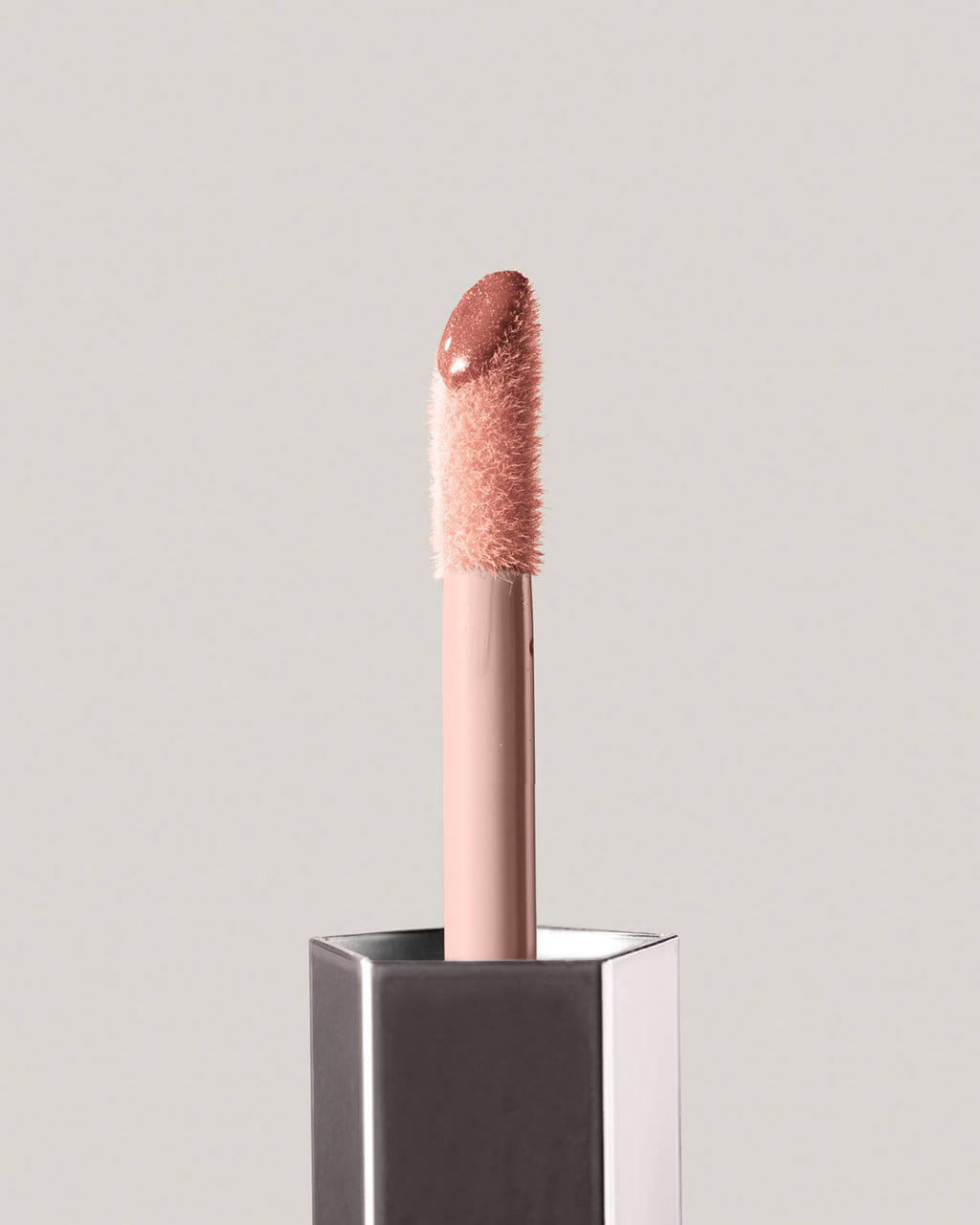Fenty Beauty GLOSS BOMB UNIVERSAL LIP LUMINIZER in shade Fenty Glow close up of doe foot applicator