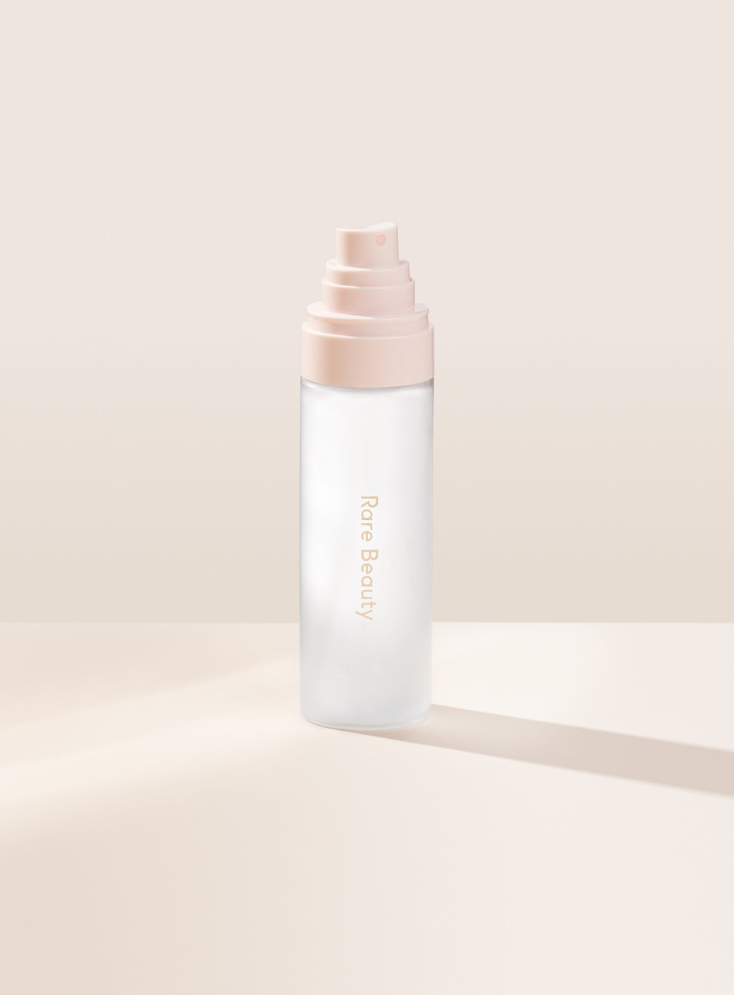 | Rare Beauty's Always an Optimist 4-In-1 Mist with the cap off, designed to hydrate, prime, set, and refresh skin. 