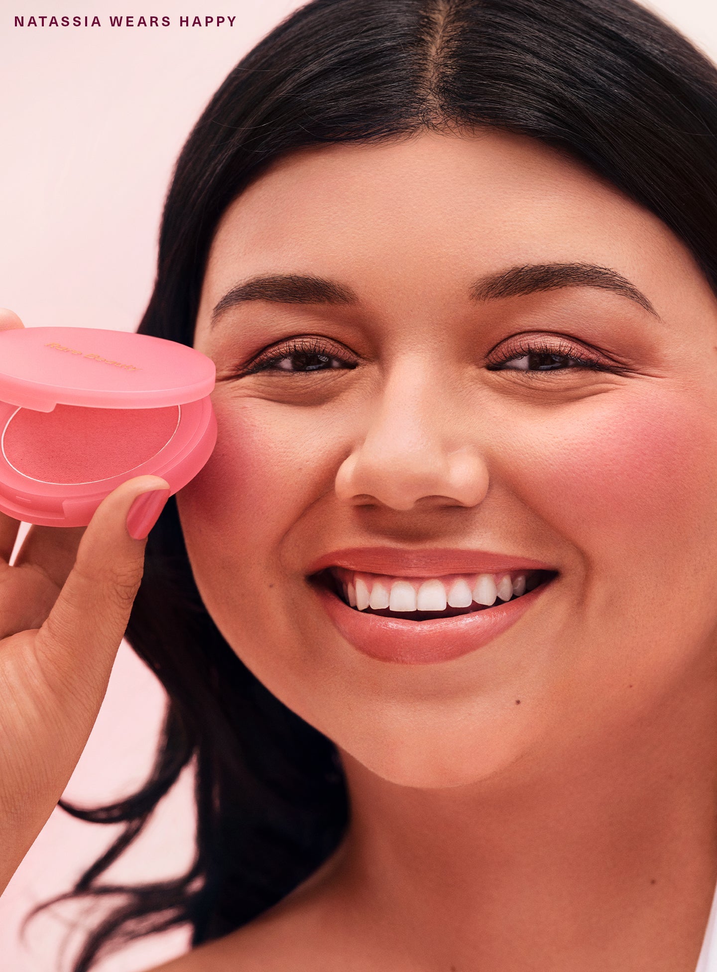 Happy| Model Natassia wearing Rare Beauty's Soft Pinch Matte Bouncy Blush in the cool pink shade Happy.