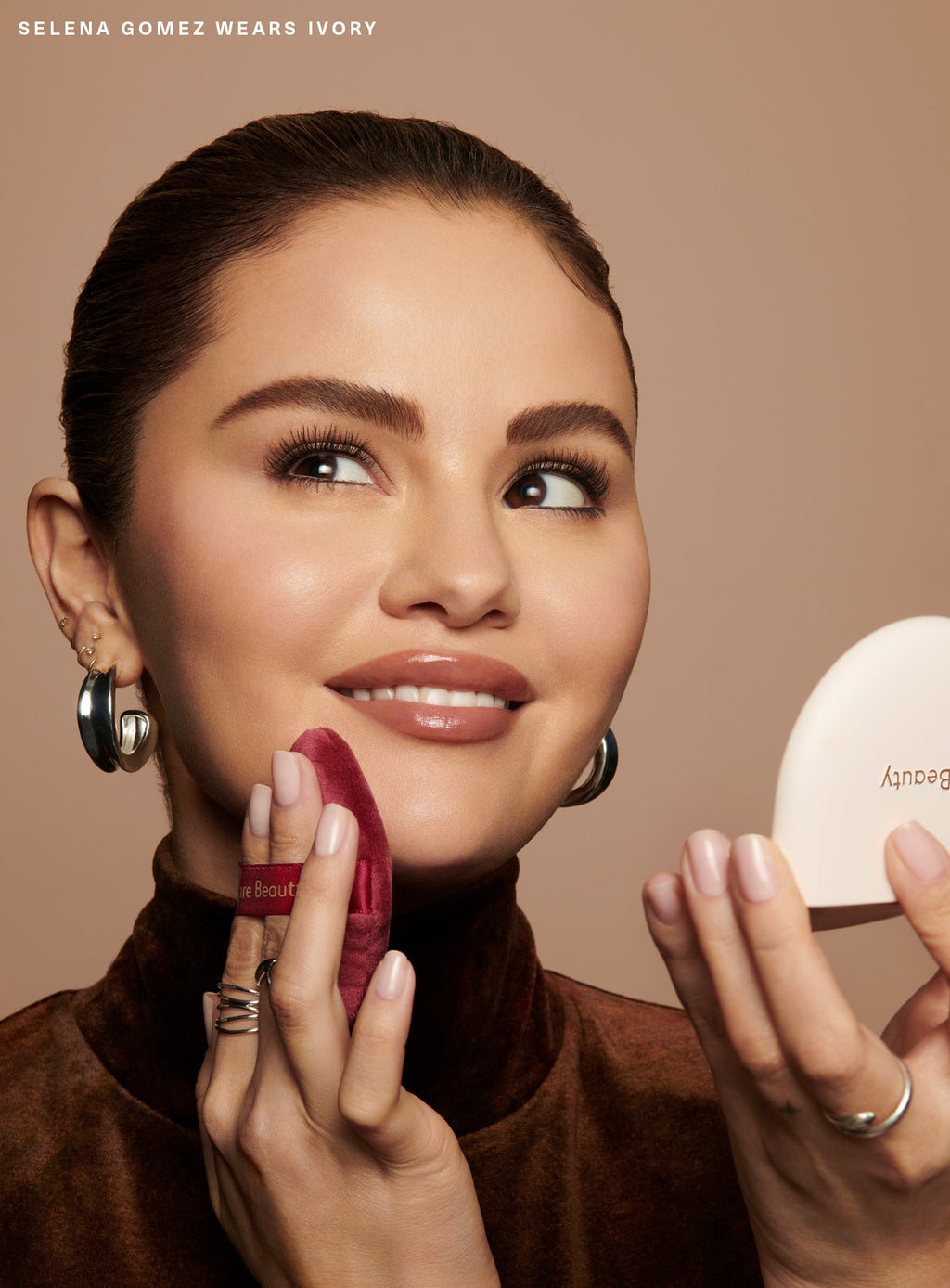 Ivory| Selena Gomez applying Rare Beauty's True to Myself Pressed Finishing Powder in the shade Ivory with the Soft Touch Powder Puff.