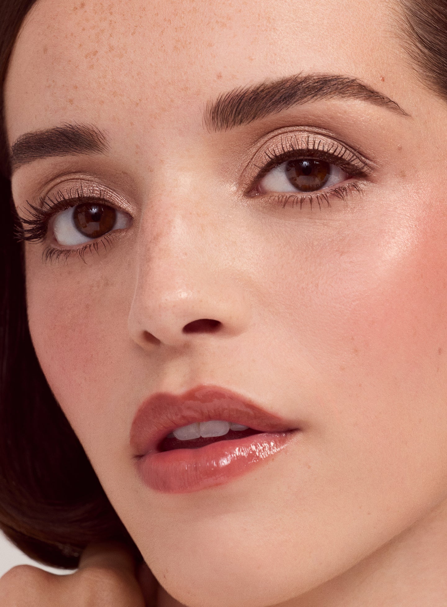 Model with light skin tone wearing a simple eyeshadow look using the Rare Beauty Essential Neutrals eyeshadow palette