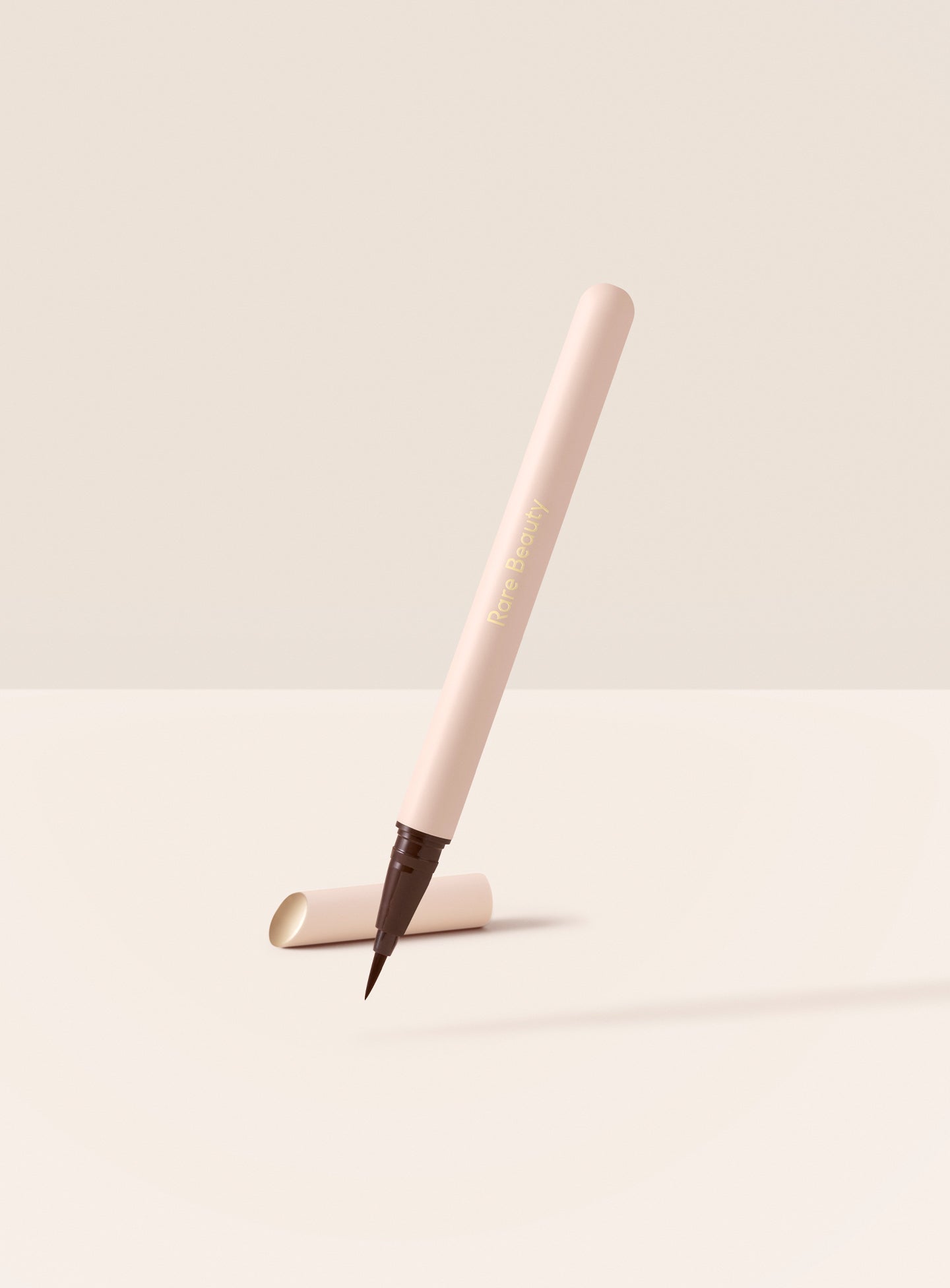 Rare Beauty Perfect Strokes matte liquid liner in brown, a waterproof liquid eyeliner with an ultra fine flexible brush tip 