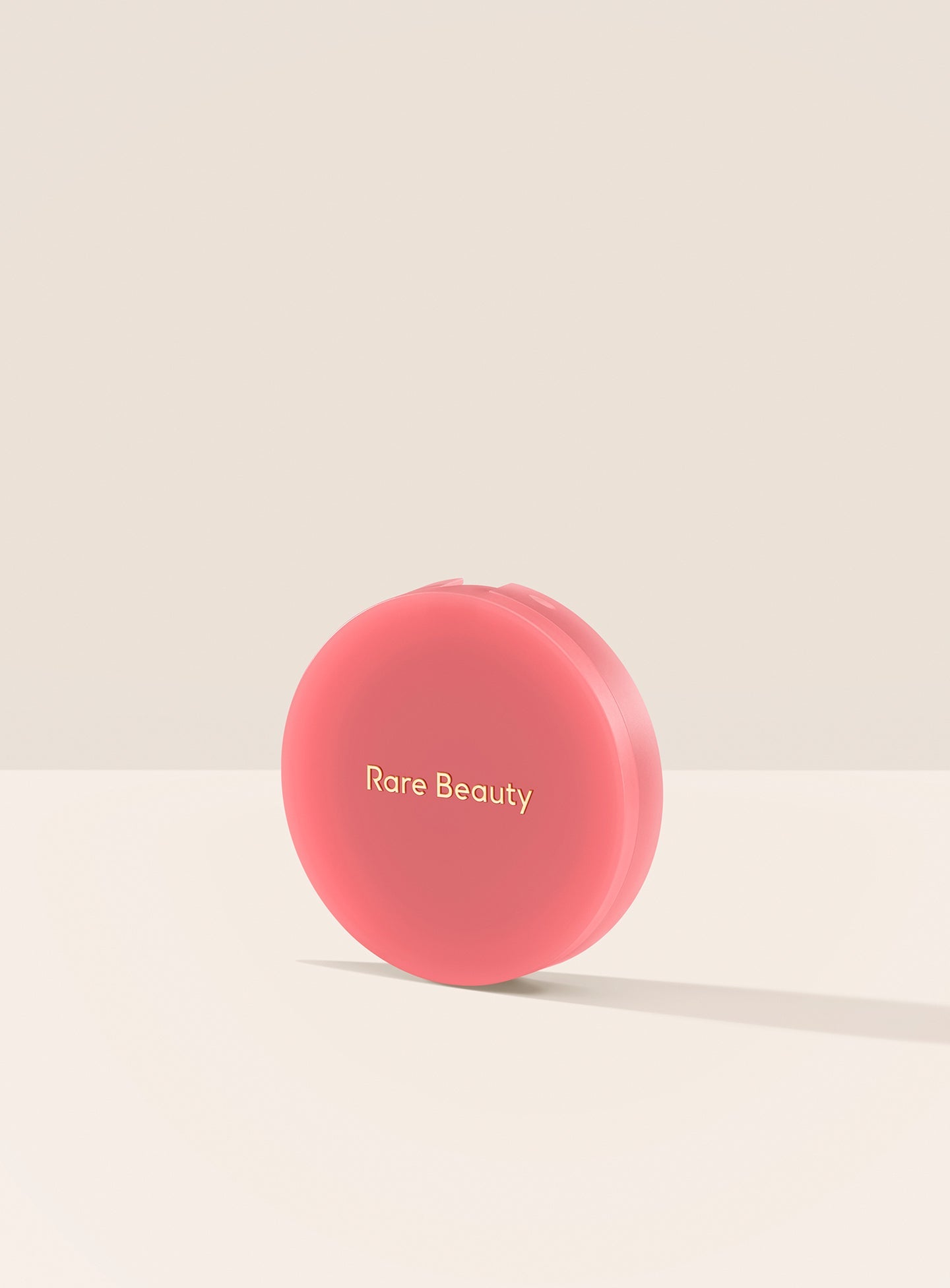 Happy| A closed container of Rare Beauty's Soft Pinch Matte Bouncy Blush in the shade Happy.