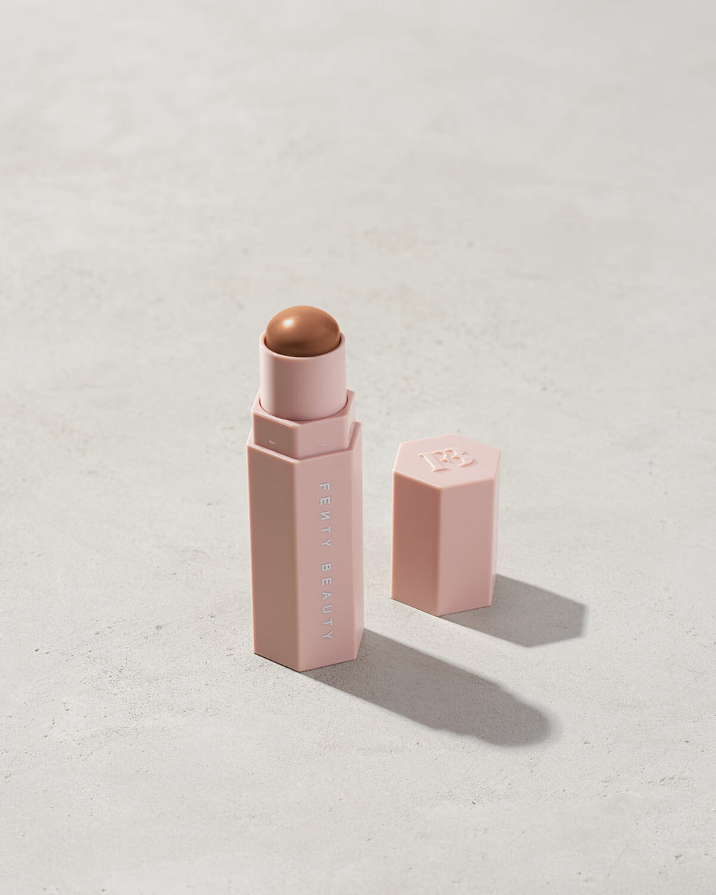 Match Stix Contour Skinstick shown in shade Truffle on a concrete background. 