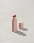 Match Stix Contour Skinstick shown in shade Truffle on a concrete background. 
