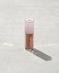 tube of Fenty Beauty Gloss Bomb Cream Color Drip Lip Cream lip gloss shown in shade Honey Waffles