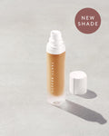 An open bottle of a new shade of Pro Filt'r Soft Matte Longwear Foundation in the shade 335 on a grey background.