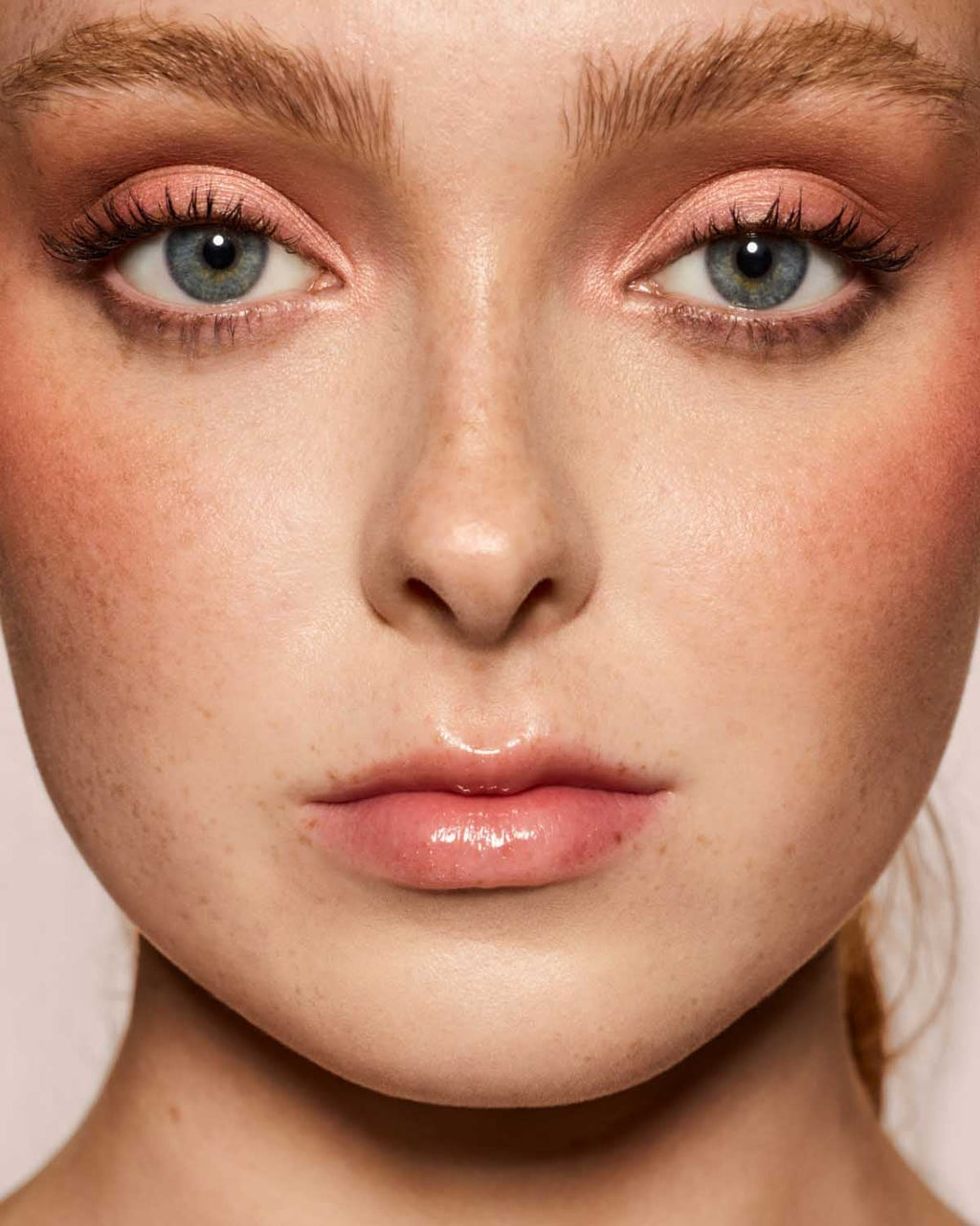 light skin toned model wearing gloss bomb universal lip luminizer in candy soda