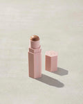 Opened Match Stix Contour Skinstick in the shade Amber Suede container on a grey background.
