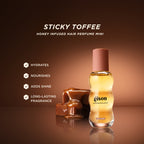 Gisou Honey Infused Hair Perfume Mini 15ml in Sticky Toffee with caramel cubes on a warm brown background, highlighting benefits: hydrates, nourishes, adds shine, and provides long-lasting fragrance.
