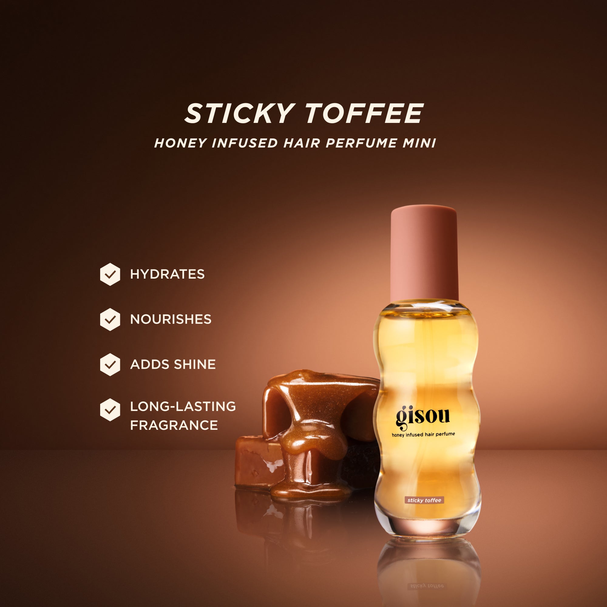 Gisou Honey Infused Hair Perfume Mini 15ml in Sticky Toffee with caramel cubes on a warm brown background, highlighting benefits: hydrates, nourishes, adds shine, and provides long-lasting fragrance.