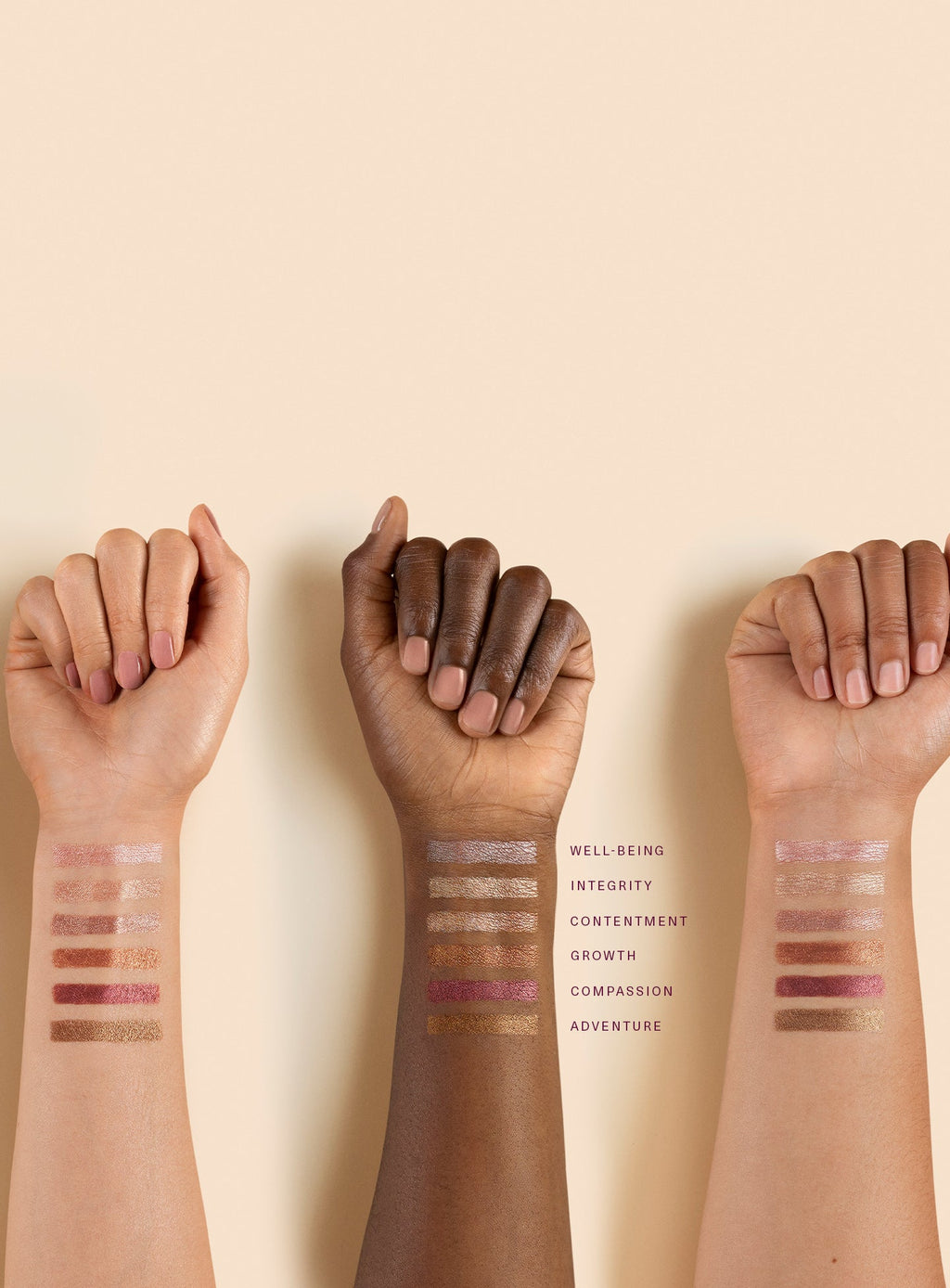 A variety of eyeshadow stick shades applied to arms of different skin tones.