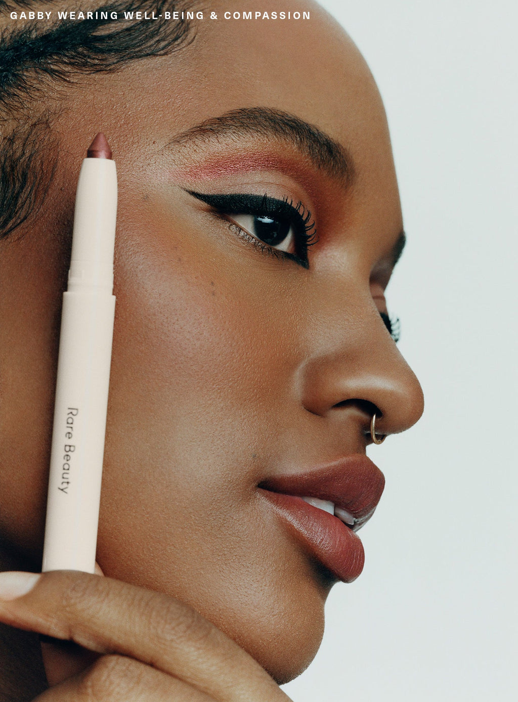Compassion| Model Gabby wearing Rare Beauty's All of the Above Weightless Eyeshadow Sticks in shades "Well-Being" and "Compassion".