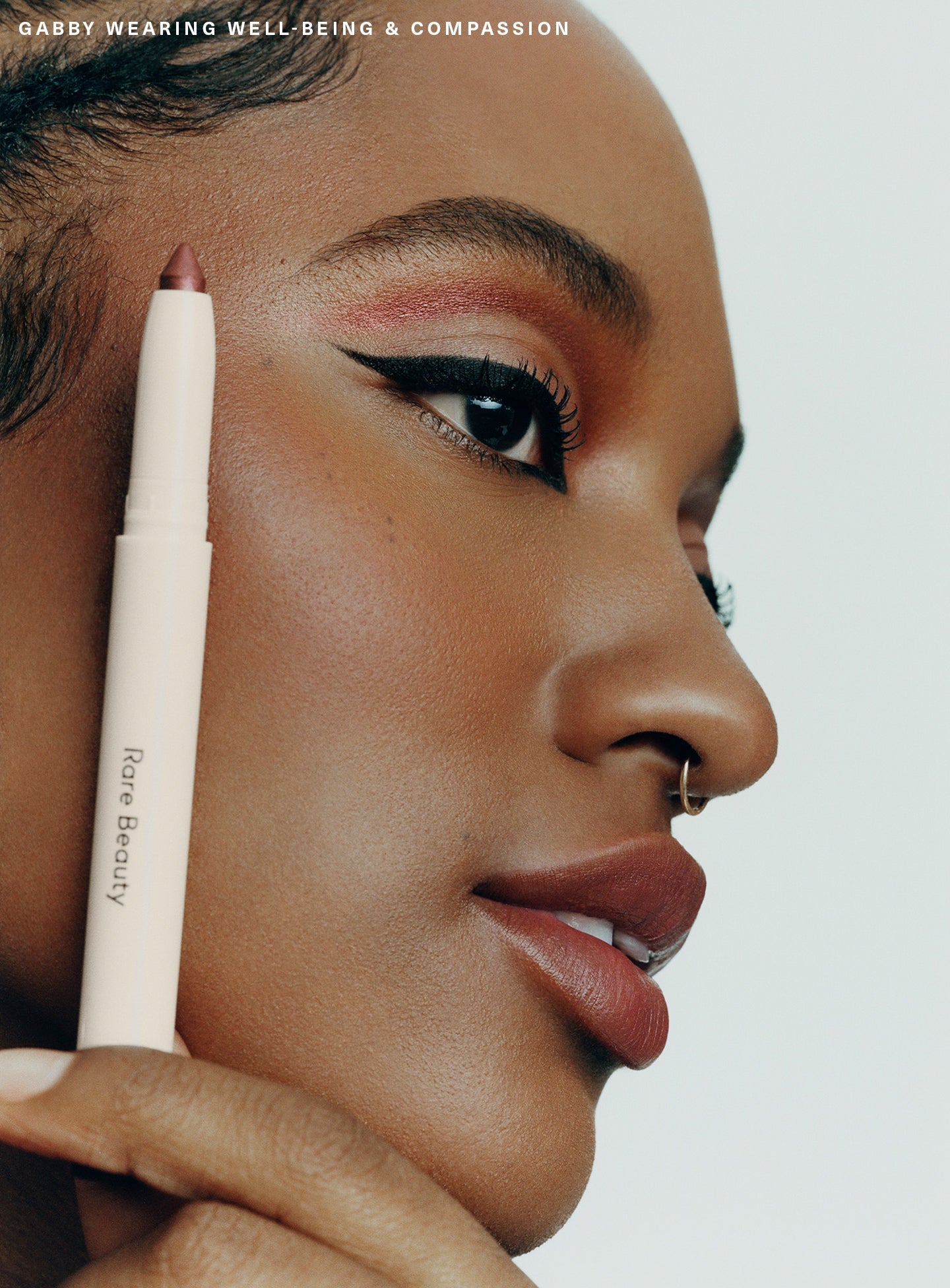 Compassion| Model Gabby wearing Rare Beauty's All of the Above Weightless Eyeshadow Sticks in shades "Well-Being" and "Compassion".