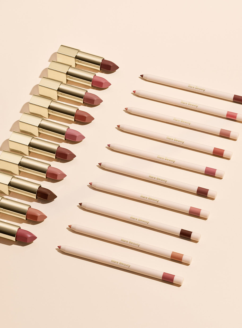 All shades of Rare Beauty's Kind Words Matte Lip Liner and Kind Words Matte Lipstick arranged neatly in two lines.