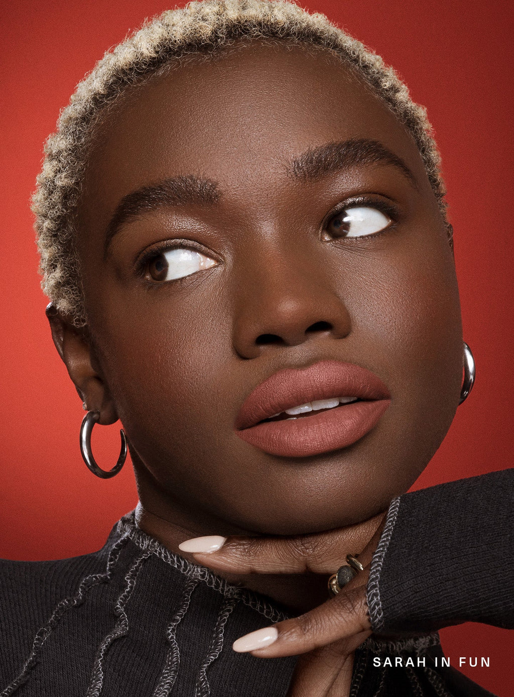 Fun| Model Sarah wearing winged eyeliner looking confident wearing Rare Beauty's Kind Words Matte Lip Liner in the shade Fun.