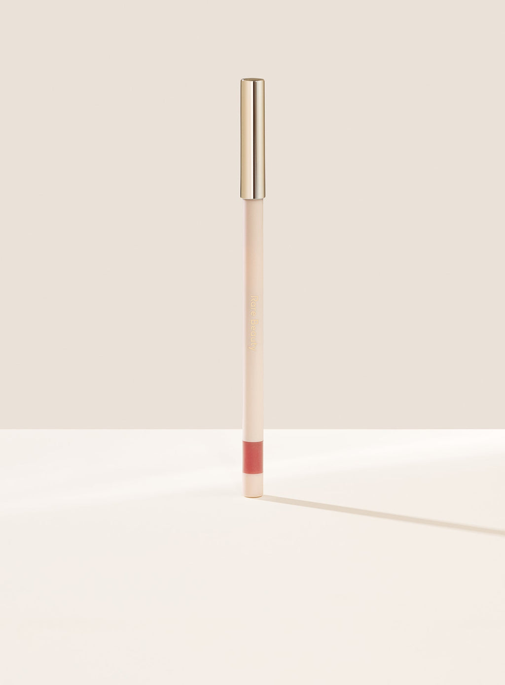 Lively| Rare Beauty's Kind Words Matte Lip Liner, a creamy waterproof lip liner in the shade Creative shown standing up with the cap on. 